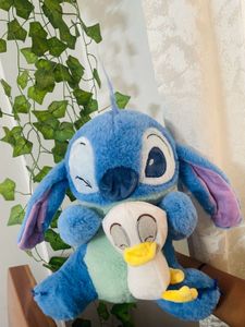 Stitch holding a duck plushie!