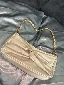 Elegant Cream Handbag with Gold Chain