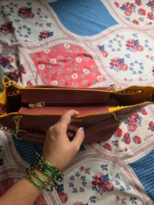 Chic Maroon Handbag with Gold Chain Accents