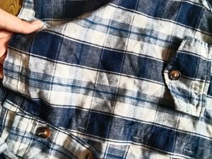 Blue Plaid Button-Up Shirt with ruffled sleeves.