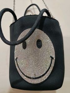 Rhinestone studded smiley face crossbody bag