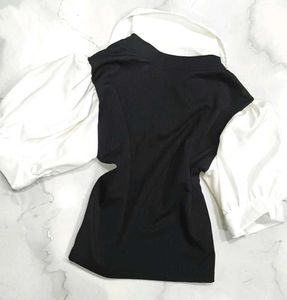 A great black top with white sleeves and collar.