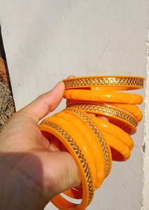 Vibrant Orange Bangle Set with Golden Embellishmen