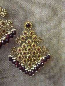 Exquisite Gold-Tone Jhumkas with Deep Red Stones