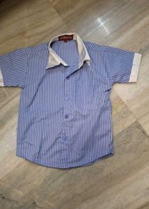 short-sleeve blue  striped  shirt  and white trous