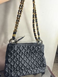 Stylish Black Textured Bag with Gold Emblem