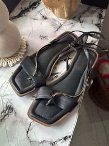 Chic Black Flat Sandals with Gold Chain Detail