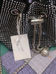 new sling potli bag black and silver in coulour...
