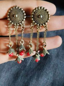 women earrings with red beads hanging