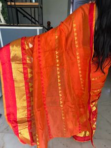 Vibrant Orange Saree with Golden Accents