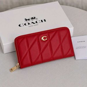 Coach Accordion Zip wallet featuring pillow quilti