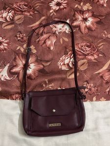 Caprese Burgundy leather sling bag