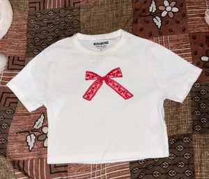 White T-Shirt with Red Bow Detail