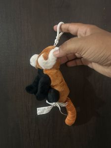 cute red panda plush keychain with a white