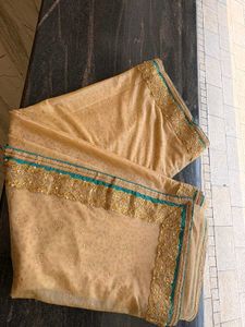 cream colour saree with peacock blue blouse