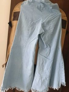 Light Wash Bell Bottom Jeans with Fringed Hem
