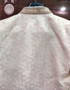 Men’s white sherwani with red velvet dhoti