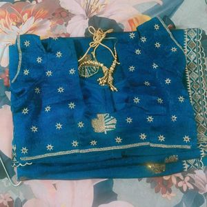 Elegant Teal Saree with Gold Embellishments