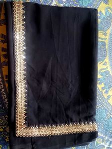 Elegant Black Saree with Golden Embellishments