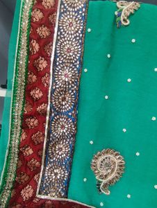 Elegant Teal Saree with Intricate Embellishments
