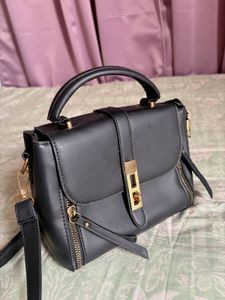 Chic Black Handbag with Gold Accents