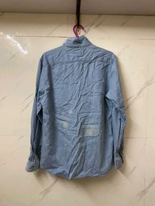 A MILDLY BLUE FADED DENIM SHIRT