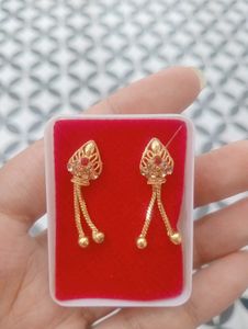 Elegant Gold Tone Earrings with Red Stones