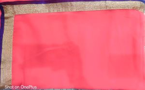 Pink colour saree with golden and purple border.