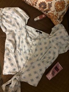 Puff sleeve tie-front top in a soft blue print.