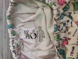 Bundle of baby clothes, beanie, shoes.