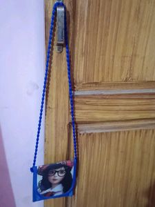Blue purse with barbie in front