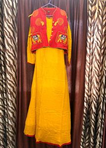 long yellow gown with red embroidered jacket