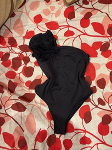Chic Black One-Shoulder Top with Flower Accent