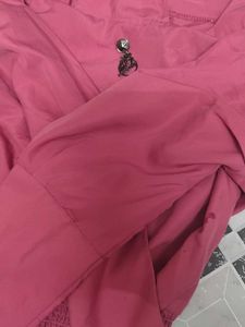 Chic Pink Smocked Top with Brooch Detail