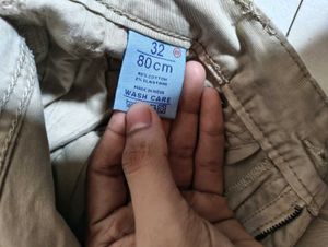 Mufti jeans in a light beige or khaki color featur