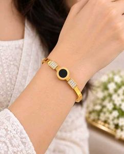 Elegant Gold Bangle with Black &amp; Crystal Accents