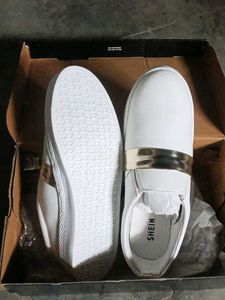 Stylish White Slip-On Sneakers with Gold Accent