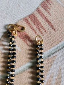 Elegant Gold Mangalsutra and stud earrings