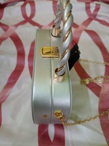 Elegant Silver Clutch with Gold Chain