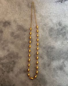 Elegant Gold Oval Bead Necklace