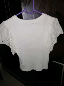 White ribbed crop top with flare sleeves.