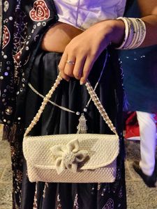 Elegant Woven Clutch Bag with Flower Detail