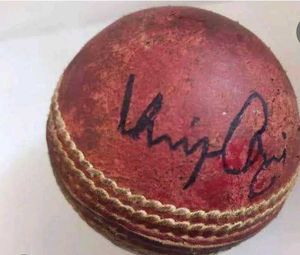 a leather ball signed by Virat and msd