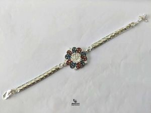 Pure Silver Designer Rakhi with Floral Embellishme