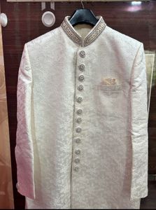 Men’s white sherwani with red velvet dhoti