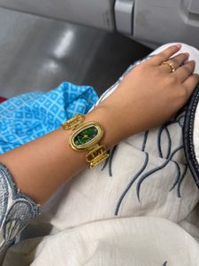 Elegant Gold Tone Watch with Green Dial