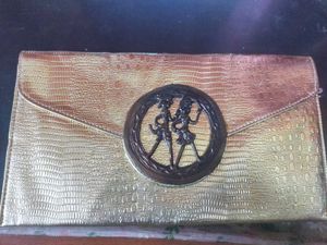 Beautiful golden Clutch with a bronze buckle