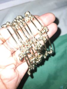 set of 8 Delicate Golden Bangles with Bell Charms