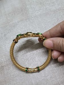 Elegant Gold Bangle with Green Stones