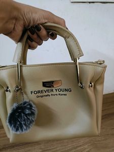 FOREVER YOUNG Beige Handbag with Pom Po